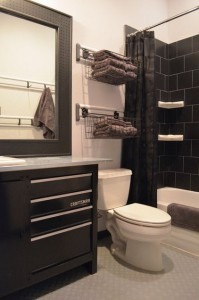 sleek clean bathroom with dark cabinets and tile