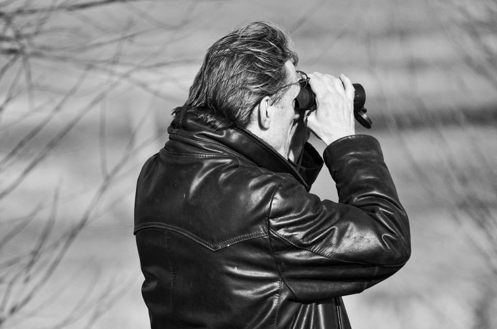 man bird watching with binoculars 