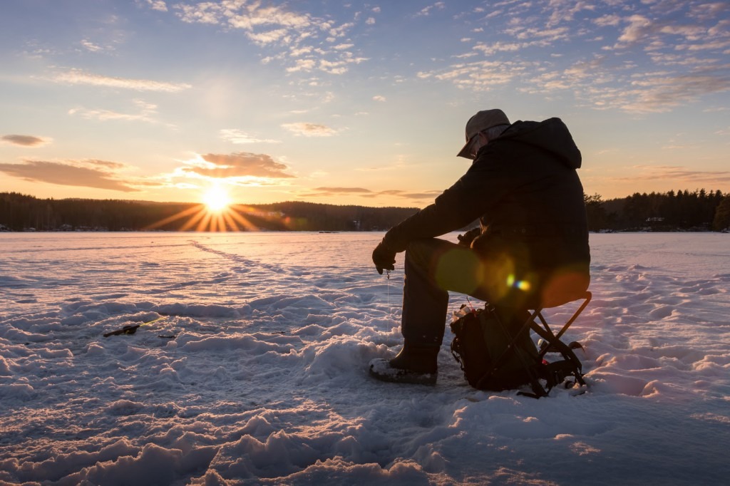 man sits on frozen lake