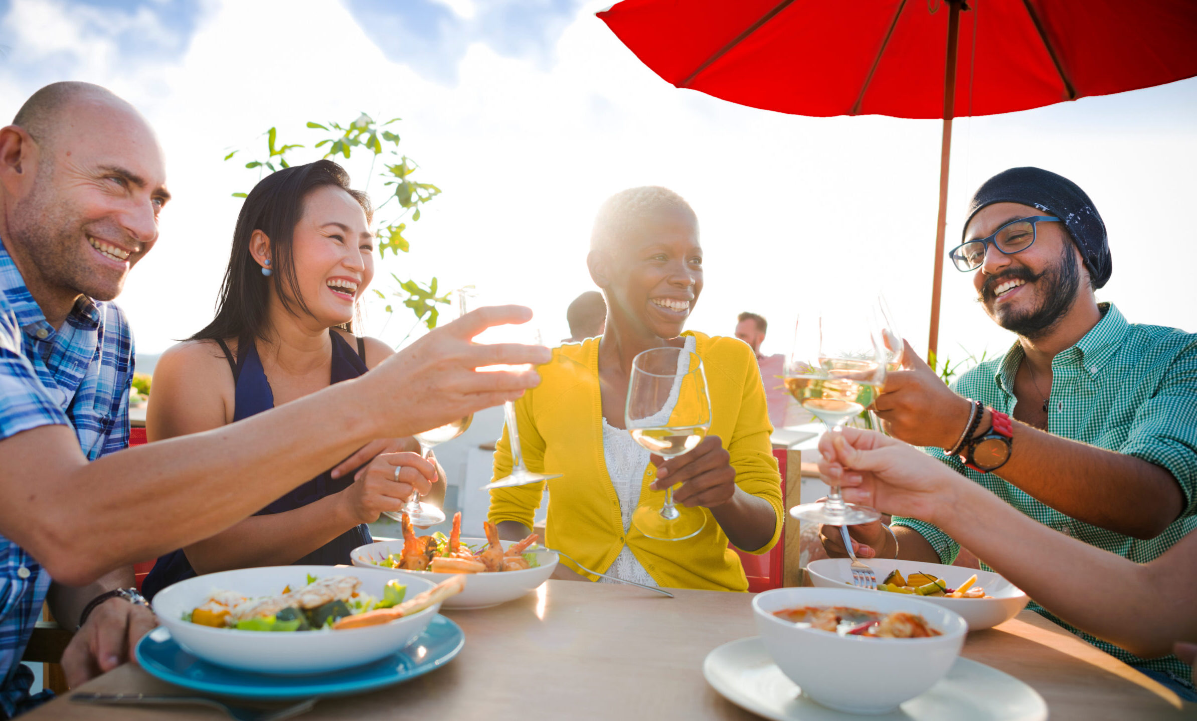 Group of happy people eating at a table
