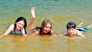 Three kids having fun in the lake