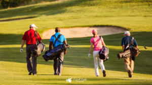 group of people walking on a golf course