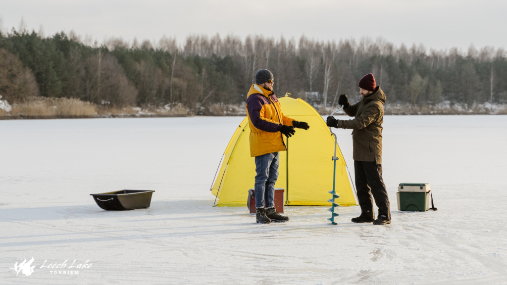 Two men ice fishing on Leech Lake